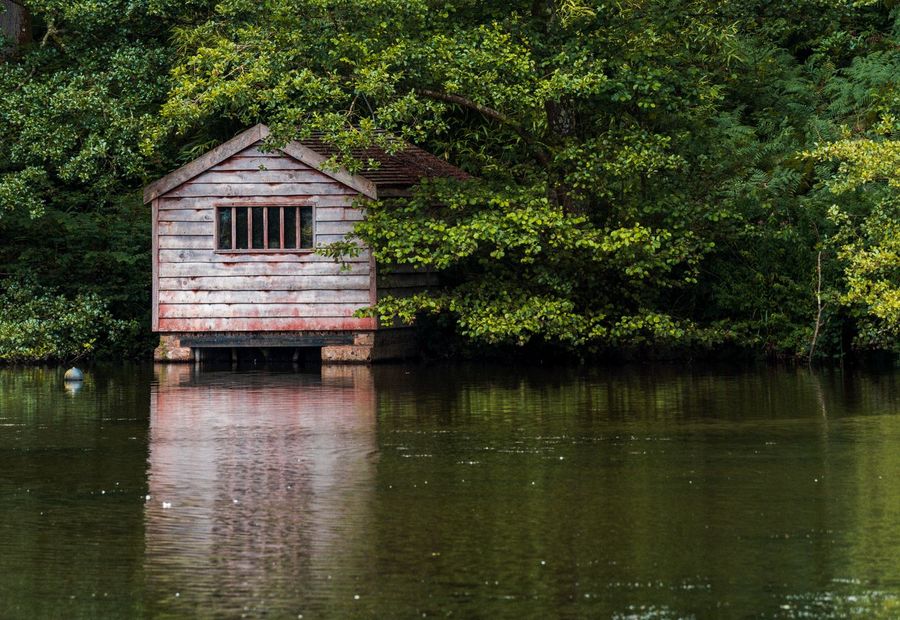 Inspector checking dock flotation and guide poles against Lake Norman shoreline permit rules
